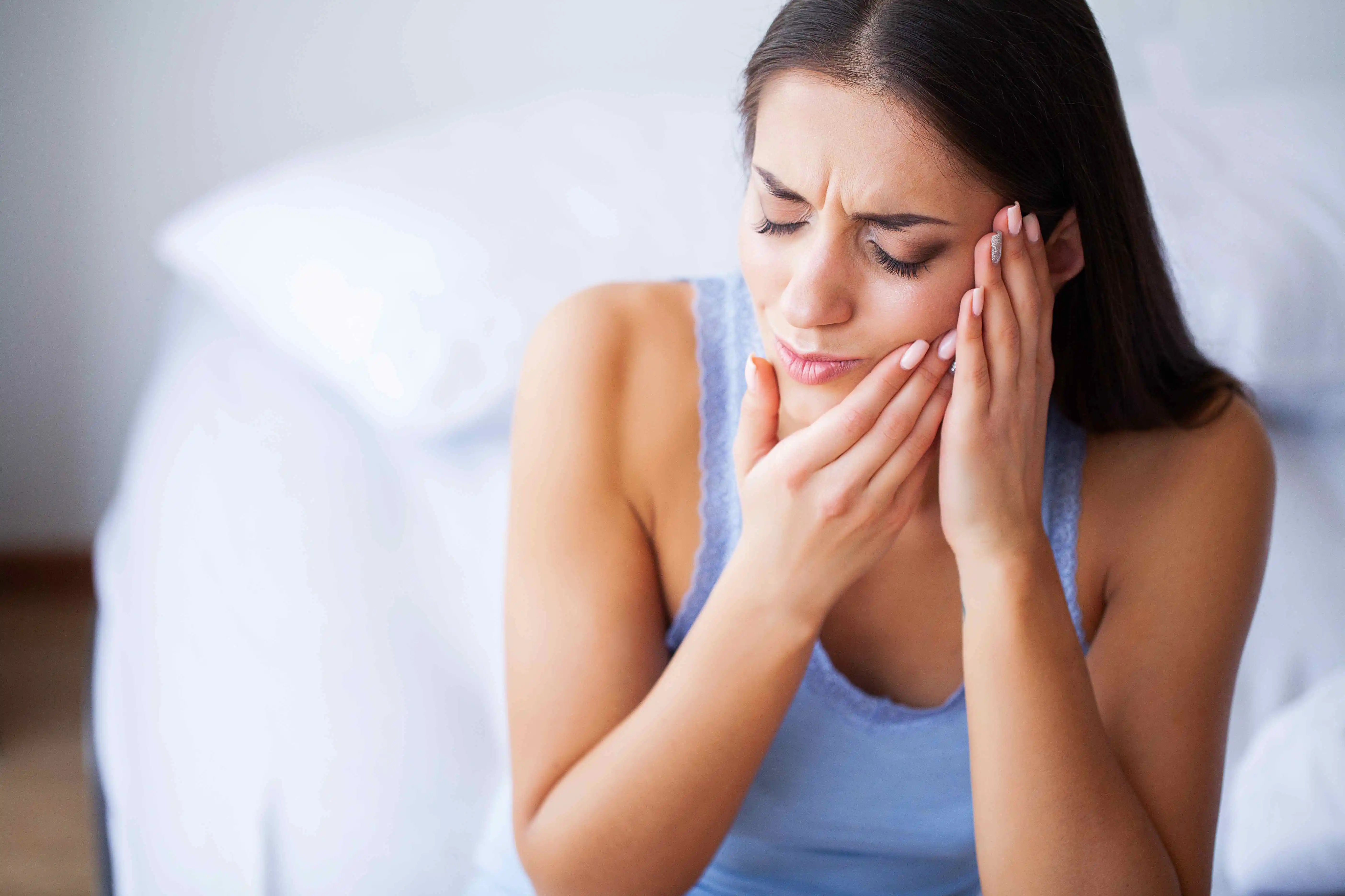 beautiful woman suffering from Common Jaw Disorders